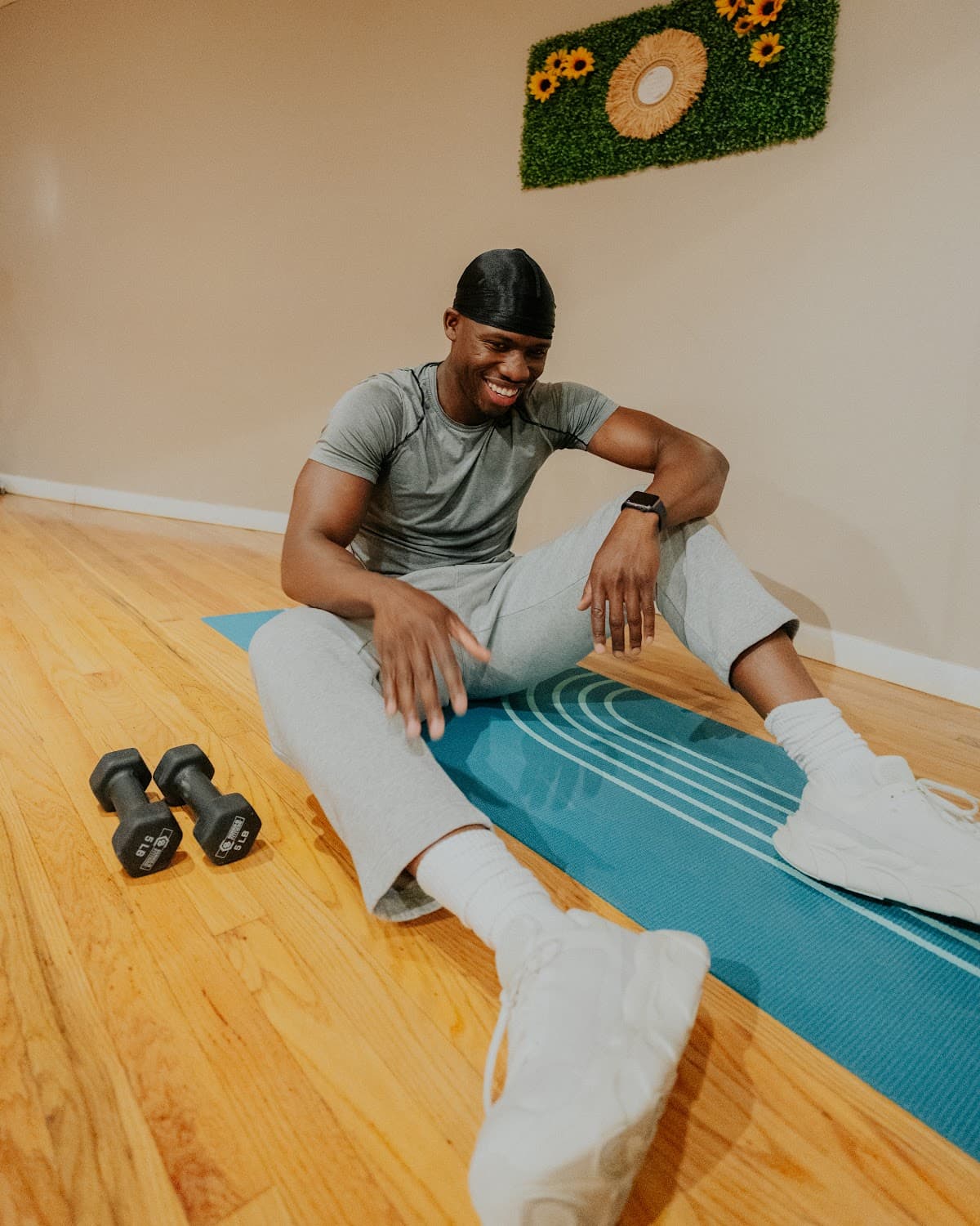 A Shape member smiling on an exercise mat