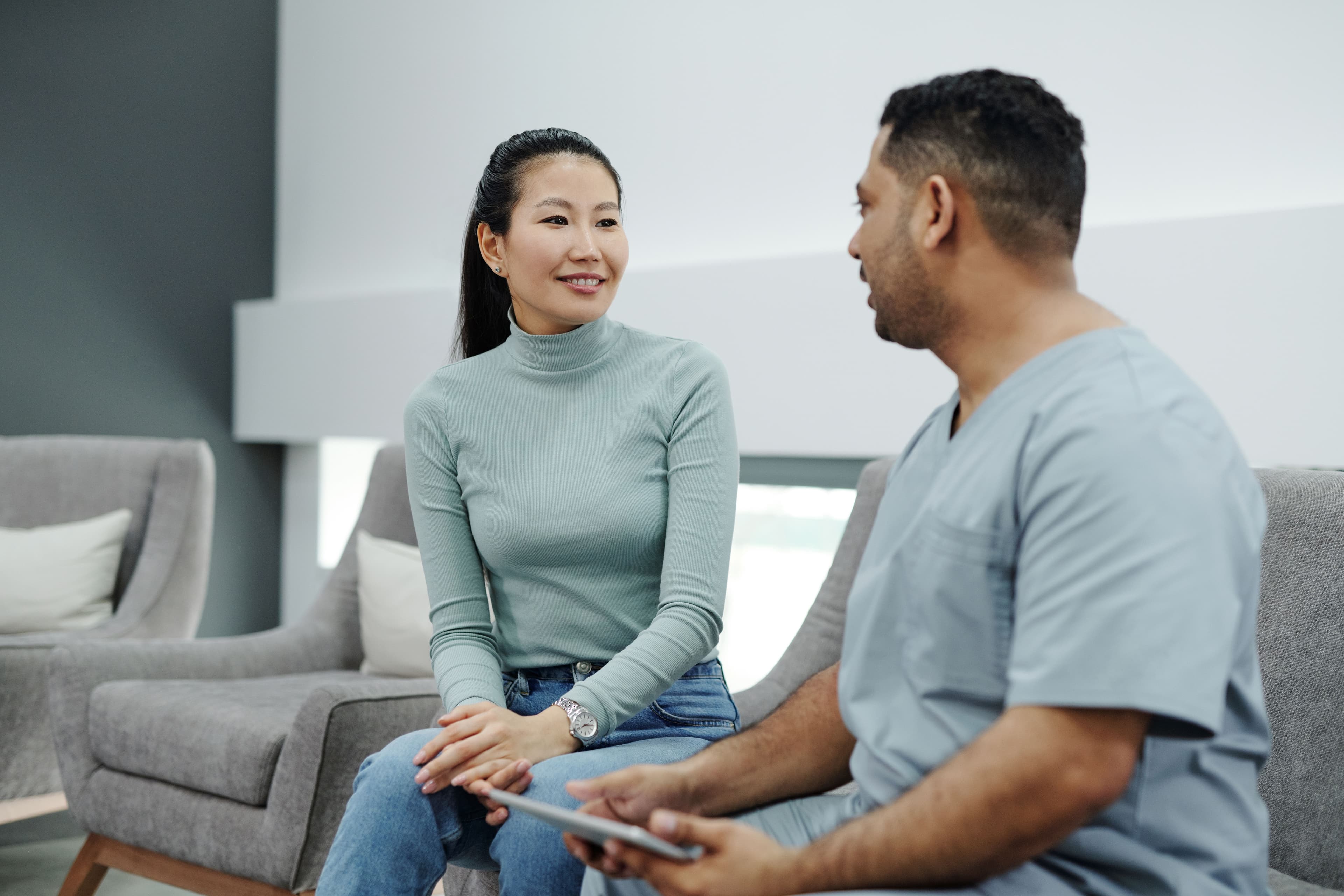 Doctor discussing a care plan with a patient using a tablet