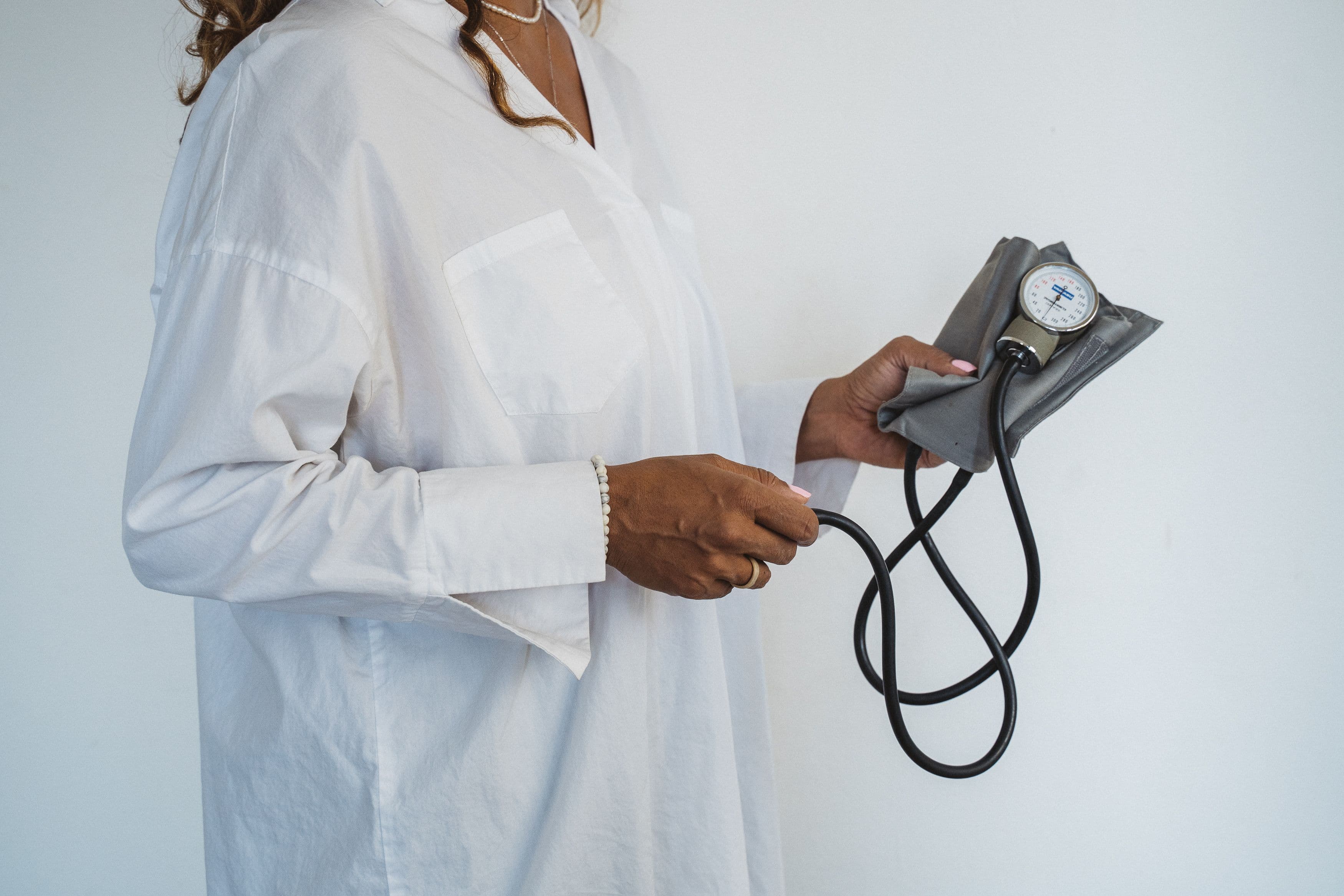Woman checking her blood pressure at home between doctor visits
